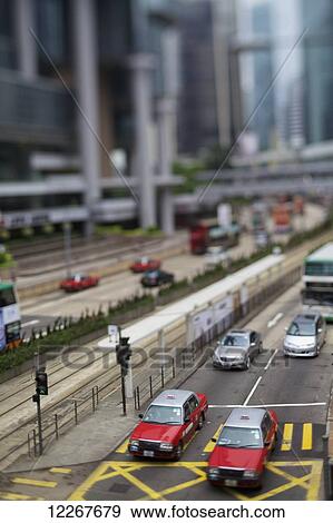 Stock Photo - Taxis and traffic on busy street; Hong Kong. Fotosearch