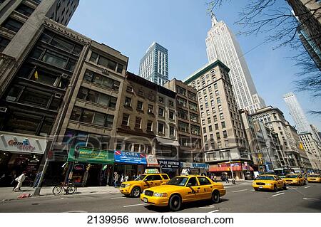 Taxis Passing In Front Of The Empire State Building, Manhattan, New York, Usa View Large Photo Image Stock Photograph - Taxis Passing In Front Of The Empire State Building, Manhattan, New York, Usa. Fotosearch