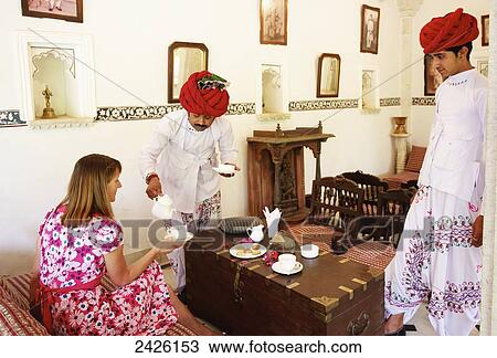 Stock Image - Tea being served to a tourist in Heritage Hotel; Rajasthan, India. Fotosearch