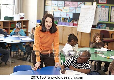 Teacher Helping Young Grade 3 Boy At His Desk In Classroom; Toronto Ontario Canada View Large Photo Image Stock Image - Teacher Helping Young Grade 3 Boy At His Desk In Classroom; Toronto Ontario Canada. Fotosearch