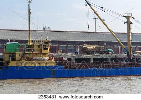 Teak Logs Are Loaded Onto A Cargo Ship For Export To China On The Yangon River; Yangon, Myanmar View Large Photo Image Stock Image - Teak Logs Are Loaded Onto A Cargo Ship For Export To China On The Yangon River; Yangon, Myanmar. Fotosearch