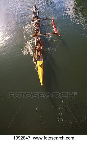 Stock Photo - Team Of Women In Outrigger Canoe Paddling, View From Above. Fotosearch