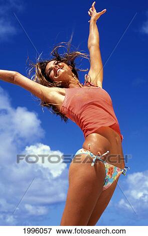 Stock Photo - Teen Girl With Arms Spread Up Against Clear Blue Sky, Joy/Freedom.. Fotosearch
