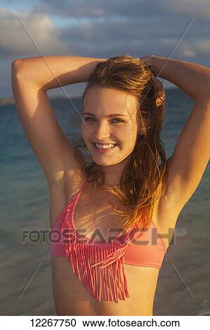 Stock Image - Teenage girl at the beach; Kailua, Island of Hawaii, Hawaii, United States of America. Fotosearch
