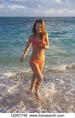Stock Photo - Teenage girl at the beach; Kailua, Island of Hawaii, Hawaii, United States of America. Fotosearch
