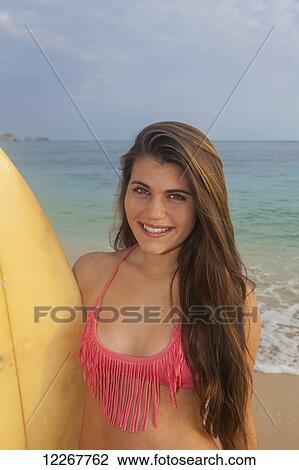 Teenage girl at the beach with her surfboard; Kailua, Island of Hawaii, Hawaii, United States of America View Large Photo Image Stock Image - Teenage girl at the beach with her surfboard; Kailua, Island of Hawaii, Hawaii, United States of America. Fotosearch