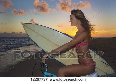 Teenage girl with bike and surfboard at the beach; Kailua, Island of Hawaii, Hawaii, United States of America View Large Photo Image Stock Photo - Teenage girl with bike and surfboard at the beach; Kailua, Island of Hawaii, Hawaii, United States of America. Fotosearch