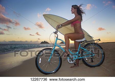 Teenage girl with bike and surfboard at the beach; Kailua, Island of Hawaii, Hawaii, United States of America View Large Photo Image Stock Photograph - Teenage girl with bike and surfboard at the beach; Kailua, Island of Hawaii, Hawaii, United States of America. Fotosearch
