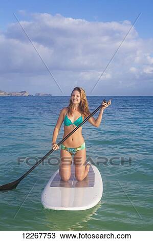 Teenage girl with her paddle board; Kailua, Island of Hawaii, Hawaii, United States of America View Large Photo Image Stock Image - Teenage girl with her paddle board; Kailua, Island of Hawaii, Hawaii, United States of America. Fotosearch