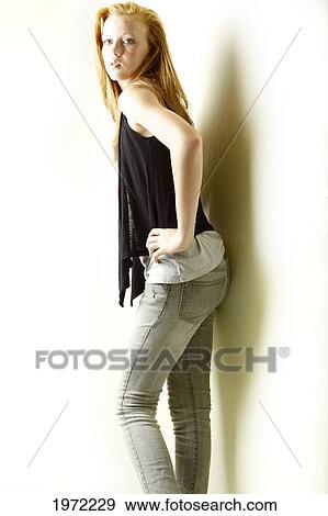 Stock Photo - Teenage Girl With Red Hair And Freckles Models Her Fashion In The Studio.. Fotosearch