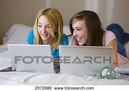 Teenage Girls Lying On Bed Using Laptops, Bradford, Ontario View Large Photo Image Stock Image - Teenage Girls Lying On Bed Using Laptops, Bradford, Ontario. Fotosearch