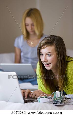 Teenage Girls On Bed Using Laptops, Bradford, Ontario View Large Photo Image Stock Image - Teenage Girls On Bed Using Laptops, Bradford, Ontario. Fotosearch