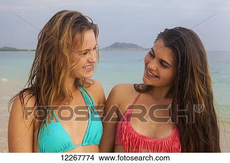 Teenage sisters at the beach; Kailua, Island of Hawaii, Hawaii, United States of America View Large Photo Image Picture - Teenage sisters at the beach; Kailua, Island of Hawaii, Hawaii, United States of America. Fotosearch