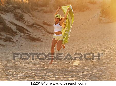 Teenager with towel having fun at the beach; Tarifa, Cadiz, Andalusia, Spain View Large Photo Image Stock Image - Teenager with towel having fun at the beach; Tarifa, Cadiz, Andalusia, Spain. Fotosearch
