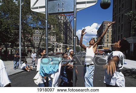 Stock Photo - Teenagers Playing Basketball. Fotosearch