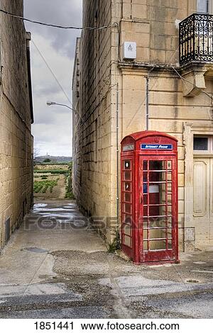 Stock Image - Telephone Booth Outside A Building; Malta, Mediteranean. Fotosearch