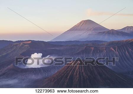Tengger Caldera with steaming Mount Bromo, Mount Batok and Mount Semeru in the background, seen from the western viewpoint at dawn, Bromo Tengger Semeru National Park, East Java, Indonesia View Large Photo Image Stock Image - Tengger Caldera with steaming Mount Bromo, Mount Batok and Mount Semeru in the background, seen from the western viewpoint at dawn, Bromo Tengger Semeru National Park, East Java, Indonesia. Fotosearch