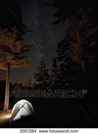 Tent Lit From Inside With Milky Way Above Seen Through Trees In Algonquin Provincial Park, Ontario. View Large Photo Image Picture - Tent Lit From Inside With Milky Way Above Seen Through Trees In Algonquin Provincial Park, Ontario.. Fotosearch