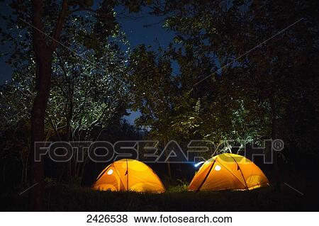 Tents pitched under the trees, camping at night; Ethiopia View Large Photo Image Stock Photo - Tents pitched under the trees, camping at night; Ethiopia. Fotosearch