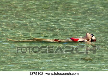 Thailand; A Woman Lays On Her Back In The Swimming Pool View Large Photo Image Stock Image - Thailand; A Woman Lays On Her Back In The Swimming Pool. Fotosearch