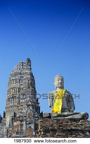 Stock Image - Thailand, Ayuthaya, Wat Chai Wattanaram, Buddha Statue And Temple. Fotosearch