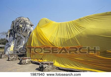 Stock Image - Thailand, Ayuthaya, Wat Logya Suthat, Reclining Buddha, Yellow Cloth Draped Over. Fotosearch