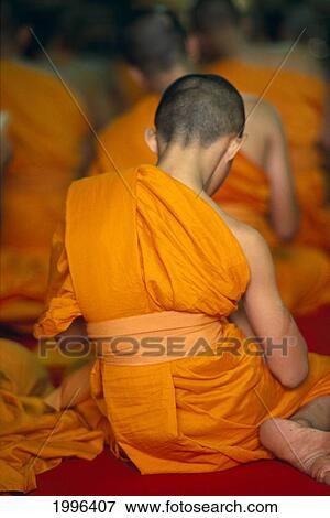 Stock Photo - Thailand, Bangkok, Chanting Monk At Wat Po, Orange Robes View From Behind A76F. Fotosearch