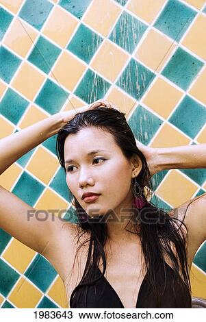 Stock Image - Thailand, Bangkok, Thai Woman In Outdoor Shower.. Fotosearch
