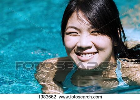 Stock Image - Thailand, Bangkok, Thai Woman In Swimming Pool.. Fotosearch