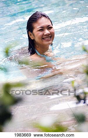 Stock Photo - Thailand, Bangkok, Thai Woman In Swimming Pool.. Fotosearch