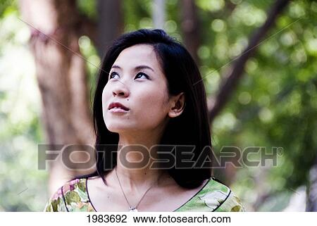 Stock Image - Thailand, Bangkok, Thai Woman Outside Walking.. Fotosearch