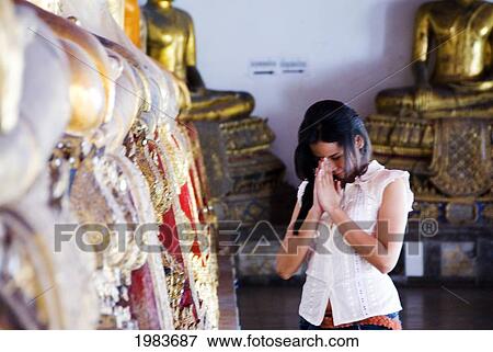 Stock Photo - Thailand, Bangkok, Thai Woman Praying At A Temple.. Fotosearch