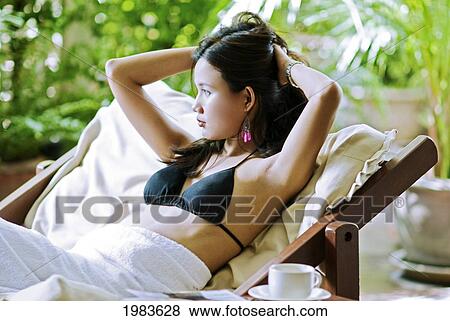 Stock Photo - Thailand, Bangkok, Thai Woman Relaxing In Spa Like Setting.. Fotosearch