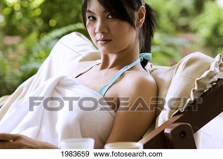 Stock Photo - Thailand, Bangkok, Thai Woman Relaxing In Spa Like Setting.. Fotosearch