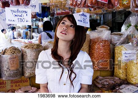 Stock Photo - Thailand, Bangkok, Thai Woman Shopping At A Dry Goods Store.. Fotosearch