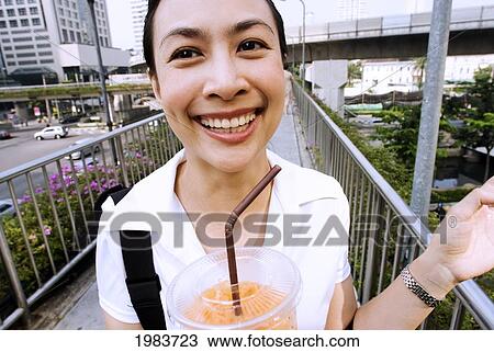 Thailand, Bangkok, Thai Woman Smiling With Drink. View Large Photo Image Stock Image - Thailand, Bangkok, Thai Woman Smiling With Drink.. Fotosearch