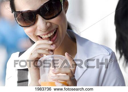 Thailand, Bangkok, Thai Woman Smiling With Drink. View Large Photo Image Stock Photograph - Thailand, Bangkok, Thai Woman Smiling With Drink.. Fotosearch