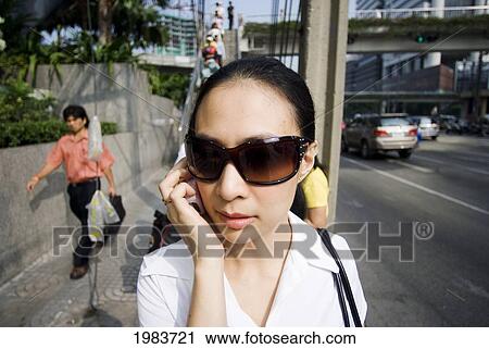 Thailand, Bangkok, Thai Woman Wearing Sunglasses On Busy Street. View Large Photo Image Stock Image - Thailand, Bangkok, Thai Woman Wearing Sunglasses On Busy Street.. Fotosearch