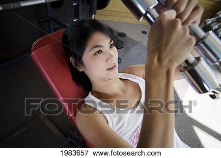 Stock Photo - Thailand, Bangkok, Thai Woman Working Out At Gym.. Fotosearch