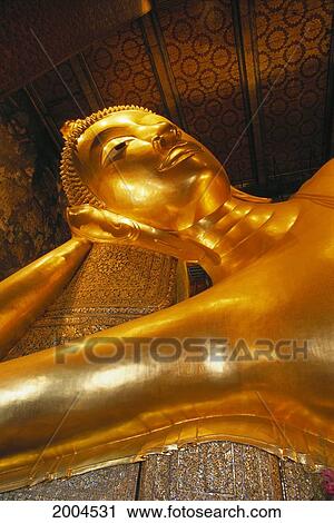 Stock Image - Thailand, Bangkok, Wat Pho Gold Reclining Buddha, Close-Up Detail Upward View, Largest 46 Meters Long Indoors. Fotosearch