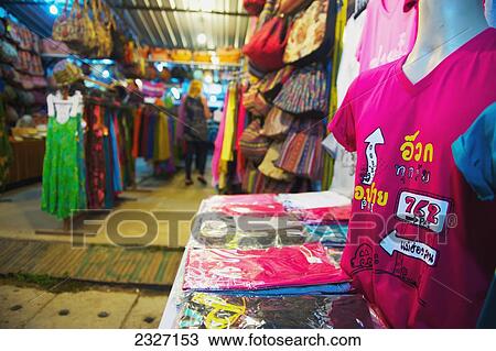 Stock Image - Thailand, Chiang Mai, Colorful clothing on display in shop; Pai. Fotosearch