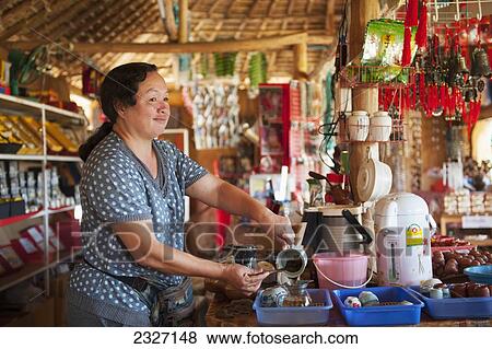 Stock Photo - Thailand, Chiang Mai, Server making beverage in restaurant; Shandicun. Fotosearch