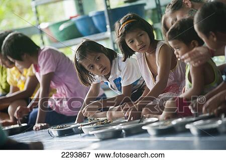 Stock Photo - Thailand, Kanchanaburi, Orphan children from The Nun's School or Karen Refugee Orphange ( Pimjai Nun Temple ) run by buddhist nun called Pimsikarn ( Maechee Pimjai Maneerat ) and popular student gap year volenteer experience; Sangkhlaburi. Fotosearch