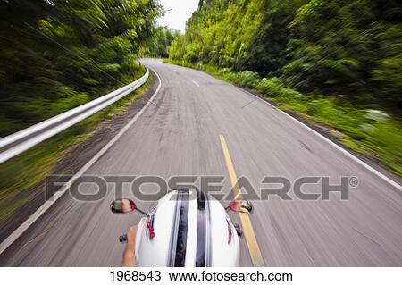 Stock Image - Thailand, Mae Sai, Bird's Eye View Of Motorbike Driving On Country Road.. Fotosearch