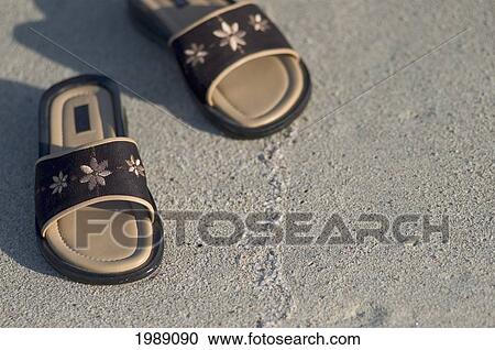 Stock Image - Thailand, Phuket, Close-Up Of Sandals On A Sandy Beach.. Fotosearch