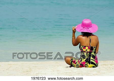 Thailand, Phuket, Kata Noi, Woman In Colorful Dress And Hat Sitting On Tropical Beach. View Large Photo Image Stock Image - Thailand, Phuket, Kata Noi, Woman In Colorful Dress And Hat Sitting On Tropical Beach.. Fotosearch