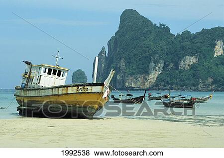 Stock Photo - Thailand, Phuket, Koh Phi Phi, Longtail Boats Docked At Beachshore.. Fotosearch
