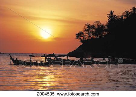 Thailand, Phuket, Scenic Along Coast With Boats Silhouetted At Sunset, Golden Orange Sky Misty Fishing View Large Photo Image Stock Photography - Thailand, Phuket, Scenic Along Coast With Boats Silhouetted At Sunset, Golden Orange Sky Misty Fishing. Fotosearch