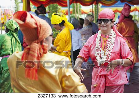 Stock Image - Thailand, Spirit mediums possessed by ancient ghosts allowing their spirits to dance while dressed in old-fashioned costume; Chiang Mai. Fotosearch