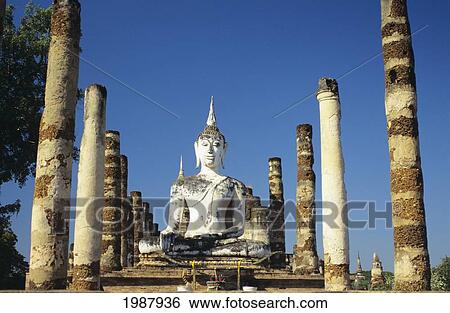 Stock Photograph - Thailand, Sukhotha, View of Buddha Statue And Pillars; Wat Mahathat. Fotosearch